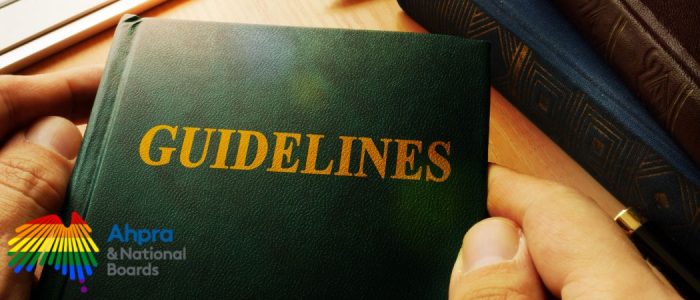Close-up of a person holding a green book titled 'Guidelines' with AHPRA & National Boards logo, related to updated aesthetic medicine regulations
