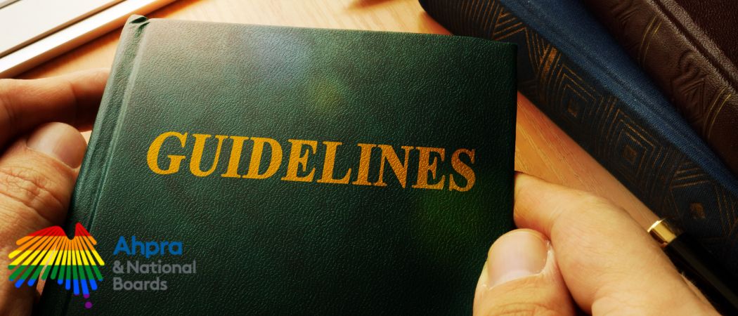 Close-up of a person holding a green book titled 'Guidelines' with AHPRA & National Boards logo, related to updated aesthetic medicine regulations